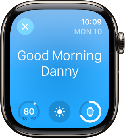 Apple Watch showing the wake up screen. The words Good Morning appear at the top. The temperature, weather condition, and battery level are below.
