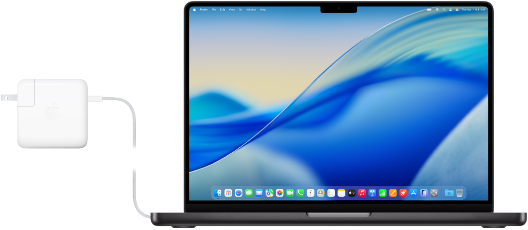 14‑calowy MacBook Pro z podłączonym zasilaczem.