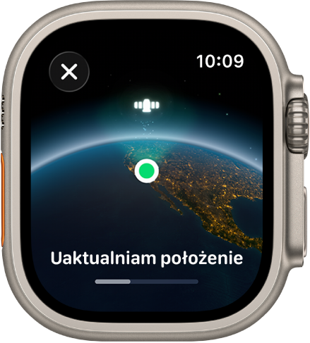 Ekran wyświetlający komunikat „Uaktualniam położenie” z paskiem postępu i widokiem Ziemi z kosmosu z zieloną kropką wskazującą lokalizację.