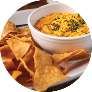 High-quality image of Buffalo Chicken Dip, served with tortilla chips, at Amici, beautifully plated.