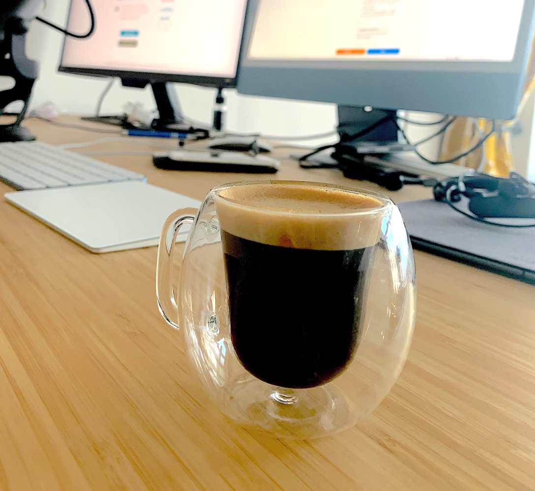 Functions in Python are like Coffee Machines - a coffee cup on a desk with computers