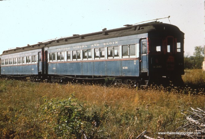 #14 - EM: Two wooden cars that had been parlor cars 600 and 601, rebuilt as coaches with metal added and reconfigured to mate with steel rather that wooden cars, in the north yard of the Wheaton shops at a time when they were seeing little use. WS: These are the two one-time parlor cars — which were built as woods and converted to operate with the steels. Photo taken at Wheaton Yard. Believe view looks N/W. FH: Nice views of the 435-436 prior to scrapping. In the lower photo, I wonder what was cut up ahead of them; I can see a traction motor armature in the pile of metal to the left.