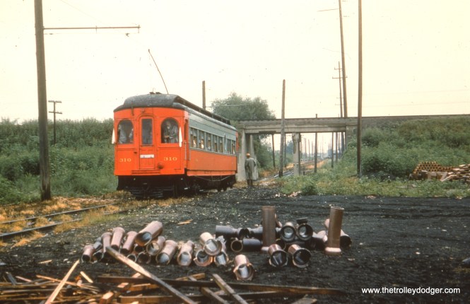 #30 - EM: CAE 310 (Hicks, 1907) would appear to be on a fan trip about to go through the underpass between the Mannheim Road section and the Roosevelt Road section of the Mt. Carmel branch (aka the Cook County branch) which was used for freight operations only after 1926. Notice the trolley pole is up. This branch was unique in that it had no third rails anywhere from Mt. Carmel cemetery to where it joined the main line. view is looking NE. AK: Cook County Branch south of IC underpass north of Roosevelt with a charter. WS: Fantrip on Mt Carmel Branch. IC Iowa Division is overhead. Bill Shapotkin writes, "The date of the photos (and there were several) of car #310 on a fantrip on the Mt Carmel Branch was (per caption on Pg 75 of SUNSET LINES (Vol1)) August 8, 1954."