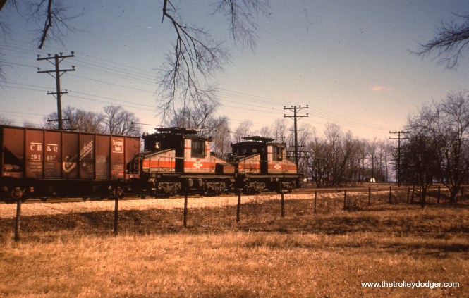#32 - WS: Nice going-away shot of a freight (locos #2001-2002). Location unknown. Jerry P. Hund says, "I belelieve #32 was taken in Bellwood, just east of Bellwood Ave. We can also see some freight cars on the IHB track that came down the trestle from the mainline. All tracks would run parallel to the CGW mainline. This view is looking northeast."