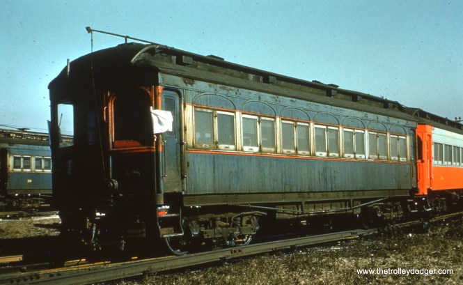 #42 - EM: CAE 48 (Stephenson, 1902) with CAE 18 (Niles, 1902) in the background, and other cars sit in the yard at Wheaton. By this time, the blue wooden cars were downright ugly.
