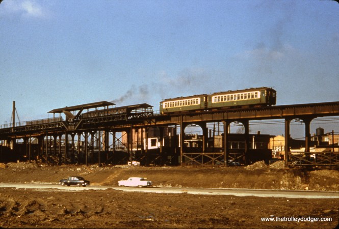 This photo shows the Kilbourn station on the Garfield Park "L" around 1954. By then, the station had been closed, and the stairways removed, in order to reduce running time due to the slow 2.5 mile temporary trackage at ground level east of Sacramento. The two-car train of CTA 4000s is about to cross the Congress Expressway, but the highway does not appear to be open yet. The "L" tracks were higher than normal at this location to cross railroad tracks just west of here. The line was relocated into the expressway median in 1958.