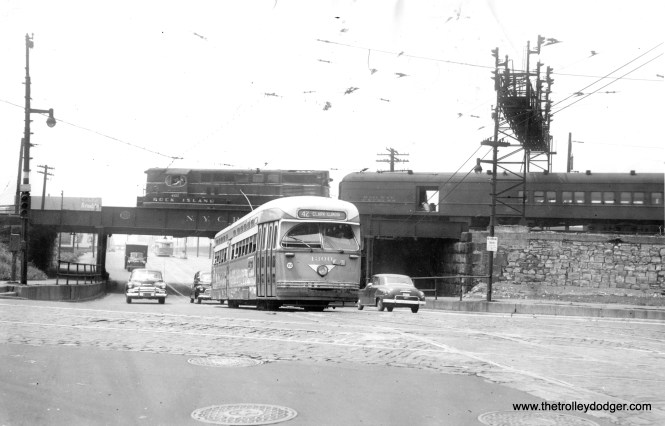 Postwar PCC 4300, heading northbound on Route 42 (which was an offshoot of the Halsted line), has just passed under the New York Central on its way towards Clark and Illinois Streets. That's a Rock Island train passing by, with a Railway Express car.