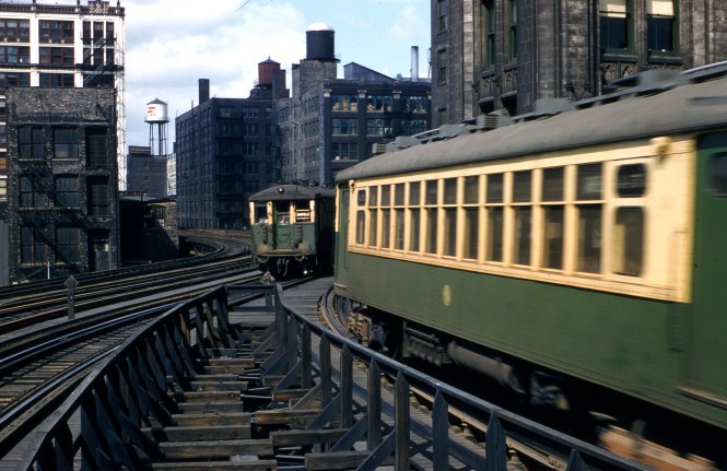 This view of two Garfield Park "L" trains is somewhere west of the Loop and was taken on April 13, 1957.