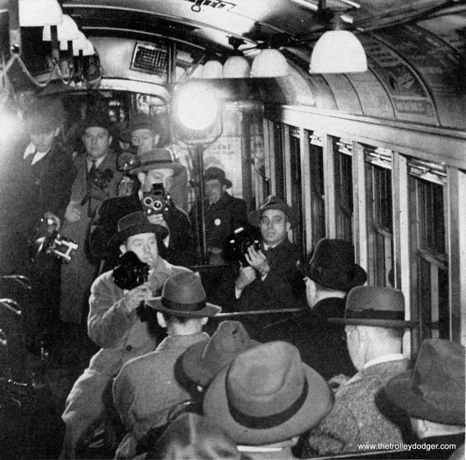 Mayor Kelly on the ceremonial train, surrounded by reporters.