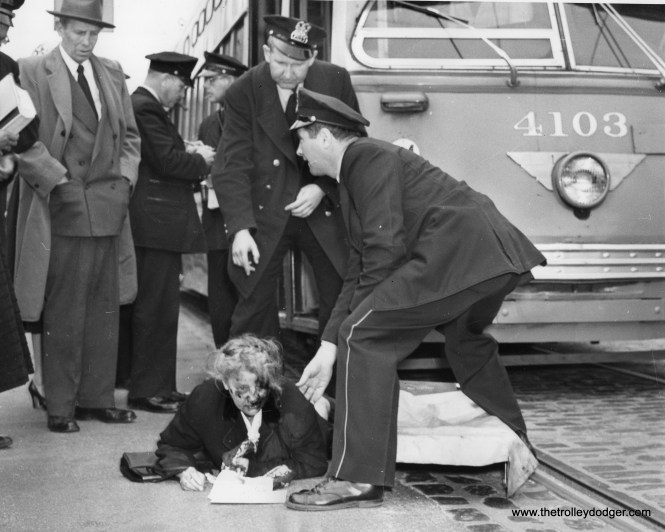 April 29, 1954: Anna Daltin, 69, of Chicago, shortly after being hit in the face by the edge of a Chicago streetcar, receives aid from police stretcher crew. she was taken to (the) hospital with a possible fractured nose and facial abrasions.