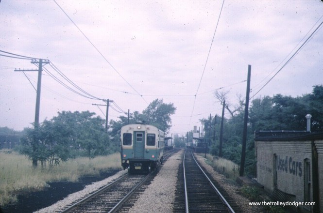 Somewhere in Evanston. Graham Garfield: "This is at Madison Street, a block or so south of Main station. Here is a view of the same location today, in a video of the line posted by CTA: https://youtu.be/tag-0WOzn7o?t=6303 (pretty soon after the video starts you'll need to pause it to study the location) -- the building on the right is the back of old Evanston Fire Station #2 (now the Firehouse Grill restaurant), and although the windows have been bricked over, the brickwork along the top of the wall facing the the track and the clay tiled parapet perpendicular to the tracks are identifiable. "