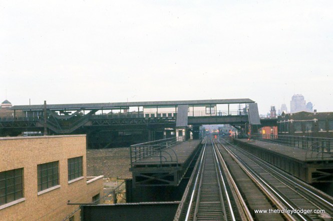 The old Lake Street Transfer station, closed since 1951. We are looking west. It was removed in 1964, along with that portion of the Paulina "L" north of here (excepting the bridge). I had originally said this was looking east. Graham Garfield: "We are looking west..." I believe we are actually looking east, from Wood St west of the station. The Met platforms began at Lake Street and projected northward (as seen in the attached Sanborn map), and in the photo they go to the left (which would be north, if we were facing east). Also, the building in the left foreground is still there today, located on the north side of Lake St near Wood St -- here is a Google Street View of it from 2009 (I chose an older one because more recently it has been repainted and had its windows changed; you can still tell it's the same building, but the older view makes it more obvious): https://goo.gl/maps/jb27nadEmRdf7BM16 "