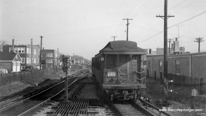 The caption on the back of this picture says this is 54th Avenue on the Douglas Park "L", however, I'm not so sure. It looks as though this is a westbound train that has just crossed over at the end of the line, but it is signed as a local and not an A or B train. M.E. writes: "Your caption is 99.44% correct, this picture has to be a westbound Douglas Park L at 54th St. in Cicero, crossing over to enter the terminal. The 0.56% in error is that it could indeed have been an all-stop train; A & B service on all lines that had A & B service was not A & B service at all times of day. As I recall, south side A & B service ran til maybe 8:30 p.m., and never on Sunday. So I contend this picture was taken on a Sunday." Kenneth Smith: "I saw this pic in your recent October Surprise post and immediately suspected that the correct location is the El Strip, north of Cermak Road, between Euclid and Wesley Avenues in Berwyn, Il. The Westbound train is approaching the end-of-line station at Oak Park Ave. Were the Westbound train really approaching 54th Avenue in Cicero, the Danly Machine Tool Company plant - not residences - would have been along the Northside of the El tracks. After a little sleuthing via Google maps found that the classic two-flats which appear on the Northside of the tracks are still there and intact. And the West facing building still features a straight roof line as shown in your photo."