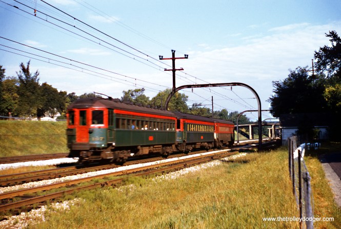 A North Shore Line train on the Shore Line Route is southbound in Winnetka in September 1954. This section was grade-separated in 1940, along with the adjacent Chicago & North Western tracks, following a series of pedestrian accidents. Harold L. Ickes, Secretary of the Interior under President Franklin D. Roosevelt, approved Federal aid that paid for part of this work, in a similar fashion to Chicago's Initial System of Subways. Ickes had lived in the area for many years. The train is moving towards the photographer, and the front is blurred due to the shutter speed that had to be used, in the days when Kodachrome was ISO 10.