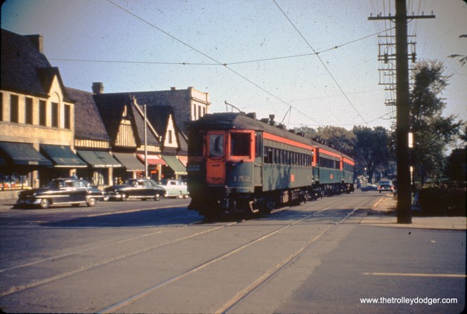 This is an Ashland Car Works duplicate slide, sold by the late Jack Bailey. This is a North Shore Line train in one of the northern suburbs, running on the Shore Line Route, parallel to the Chicago & North Western (which would be just to the right of the frame). Which means we are looking to the south. KV writes that this "appears to be St. Johns Avenue in Highland Park."