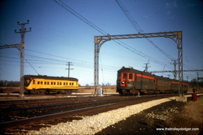 North Shore Line 758 heads up a four-car train, while a nearby Milwaukee Electric interurban is visiting on a 1949 fantrip.