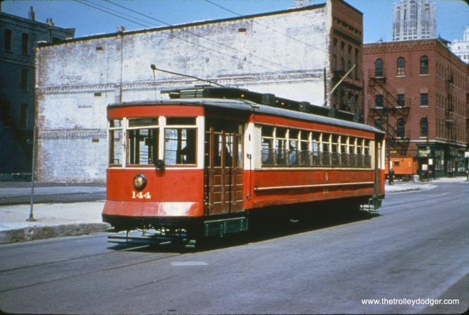 CTA red Pullman 144, which is now at the Illinois Railway Museum. Not sure whether this photo was taken during a 1950s fantrip, as so many other pictures were. Mike Franklin: "Heading west on Kinzie Street just west of Dearborn. Tribune Building in the distance."