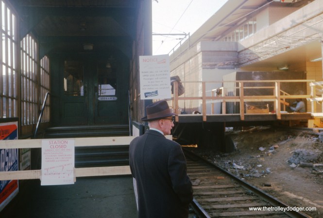This photo by the late William C. Hoffman was taken on October 28, 1962 at the Central Avenue station on the Lake Street "L", and shows how the transition was made from the ground level operation to the new alignment on the C&NW embankment. Unlike the situation in 1958, when the new Congress rapid transit line and the old Garfield Park "L" both ran on the same day, that was not possible here, due to the tight clearances at the station entrances. The new entrances could not be finished until the old line was torn out. So on October 28, 1962, which was a Sunday, the ceremonies dedicating the new 2.5 mile "L" realignment were held in the morning, and then, until 6 pm, trains only ran as far as Laramie Avenue, where the steel "L" structure ended. While workers put wooden platforms over the old tracks, riders west of Laramie had to take shuttle buses on Lake Street, as the signs here indicate. Passengers still had to enter via the old station entrances for a time.