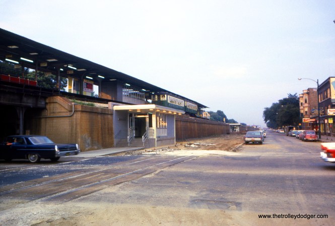 The view looking east/northeast along Lake Street (now Corcoran Place) at Austin Boulevard on August 12, 1963. The new station entrance has been finished. (William C. Hoffman Photo)