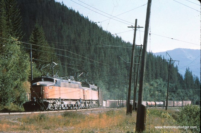 Subject: The Milwaukee Road Location: Pacific Northwest Photographer: Unknown Date: August 1971 (processing date) In the early 1900s, the Milwaukee Road electrified over 600 miles of freight trackage in the northwestern United States. Use of electric locos ended in 1974. This was a very picturesque, if not a profitable, operation. Large parts of it were eventually abandoned. M. E. adds, "Your caption mentions freight trackage. Passenger trains used this line too, particularly the flagship Olympian Hiawatha. The electric locomotives in the picture were called Little Joes (after Joseph Stalin) because they were originally intended to go to Russia, but the U.S. government negated the shipment. The Chicago, South Shore and South Bend also had some Little Joes. By the way, the Milwaukee Road used electric locos to go through tunnels safely. There was a second section of electrified trackage in Washington State as well."