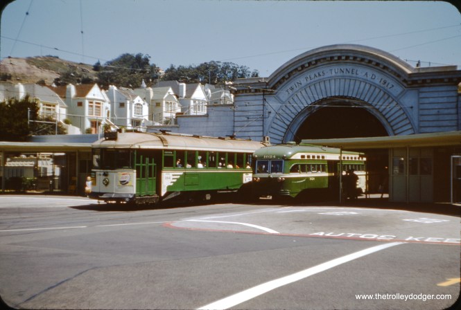 Subject: SF Muni Iron Monster Streetcar #184 (and PCC 1024) Location: San Francisco, CA (at the entrance to the Twin Peaks Tunnel) Date: June 22, 1954 Photographer: J. W. Vigrass Muni bought 125 of these cars from the long-vanished Jewett Car Co. in Ohio and put them to work hauling passengers to the 1915 Panama Pacific International Exposition. The cars were big - 47 feet long - and heavy - 24 tons each - and famously slow. They were painted battleship gray at first and then green and cream. San Franciscans called them "Iron Monsters." They were all retired by 1958. A few were saved by museums and by the Municipal Railway.