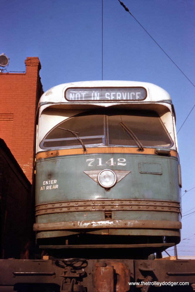 On May 25, 1958, we see Chicago Transit Authority PCC #7142 mounted on a flatcar at South Shops for transport to the St. Louis Car Company. This was less than a month before the end of streetcar service in Chicago. Approximately 570 of the 600 postwar Chicago streetcars retired early and shipped to St. Louis as part of the so-called PCC Conversion Program, where they were scrapped and some of their parts (seats, motors, windows, etc.) were recycled for use in new rapid transit cars. The final two dozen PCCs were simply scrapped. (Robert D. Heinlein Photo)