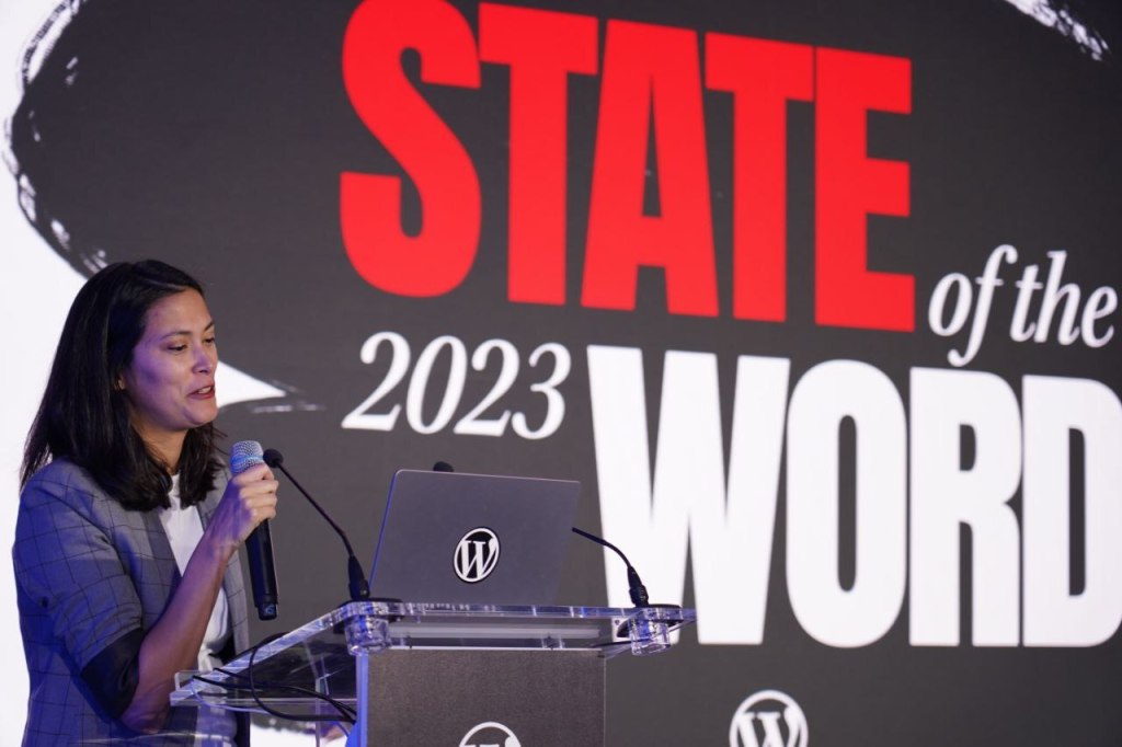 Josepha Haden Chomphosy, Executive Director of the WordPress project, speaking at a podium
