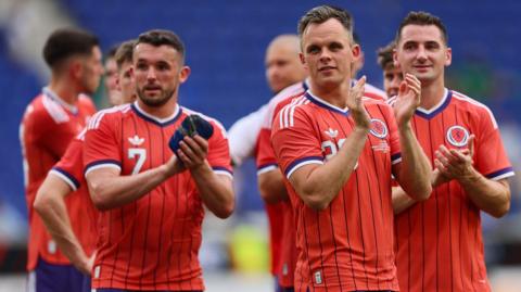 Scotland players celebrate victory over Bolivia by clapping fans at the end of the game
