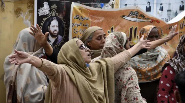Relatives of victims react at the scene of a suicide bomb blast targeting a Shiite Muslim mosque