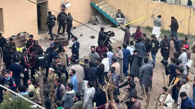 People shift injured victims of a blast at a Shiite Muslim mosque to hospitals in Islamabad