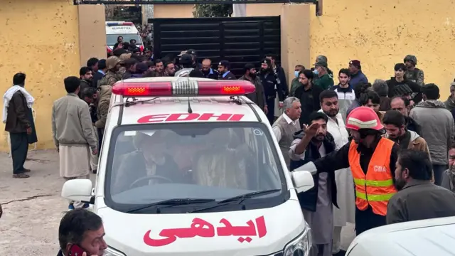 People shift injured victims of a blast at a Shiite Muslim mosque to hospitals in Islamabad