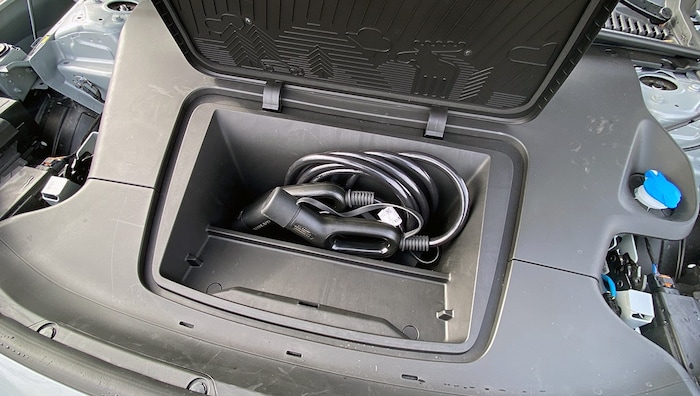 Folding artists manage to stow the charging cable in the frunk.