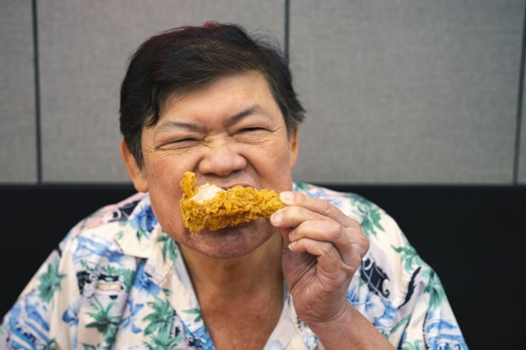 man eating fried chicken