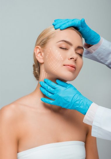 Photo of a woman being examined by a plastic surgeon