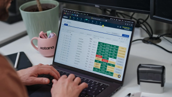 Team reviewing centralized sales orders in Katana from multiple sales channels on a laptop