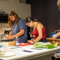 First-year students chopping vegetables.