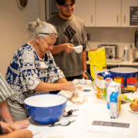McMaster Welcome week representative rolling dough.