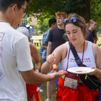 Representative painting a first-year's hand red.
