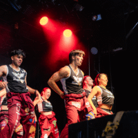 Representatives dancing on stage wearing jerseys that read 'MSU MAROONS'.