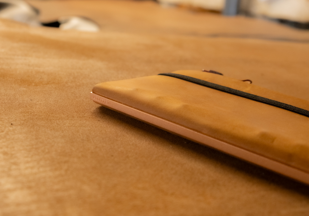 Predator Amber Leather Binder in Narrow Size against a large sheet of leather.