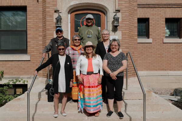 Survivors stand on the stairs outside Chancellor’s Hall.