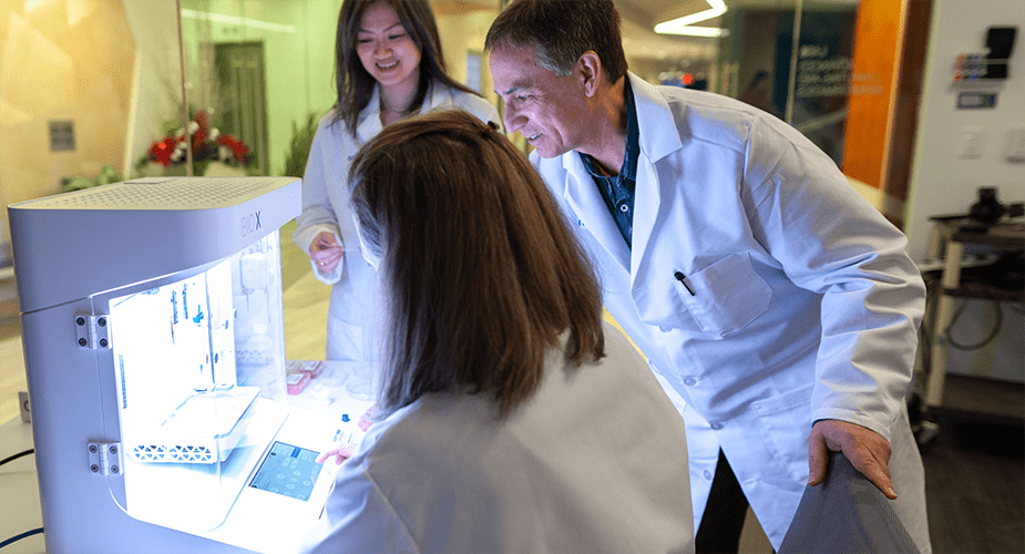 scientists looking at lab equipment