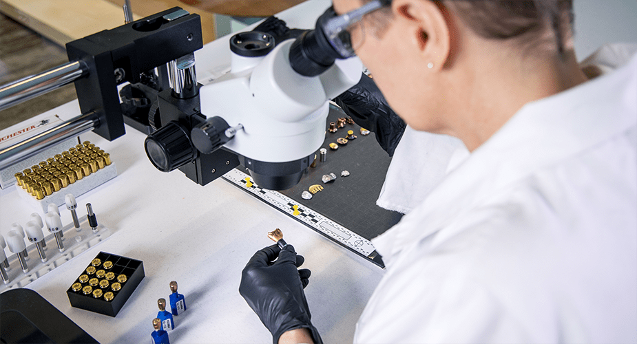 woman looking into microscope