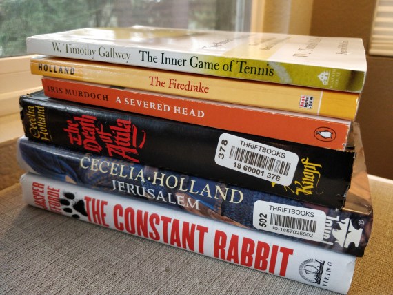 A stack of books on a shelf, with most of them mentioned in this post