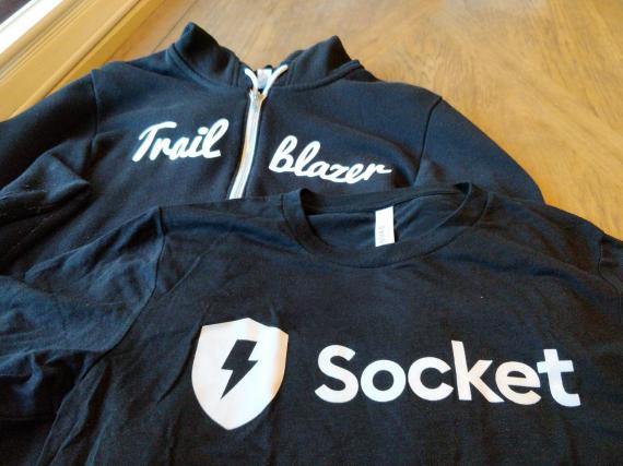Photo of a Salesforce Trailblazer hoodie next to a Socket t-shirt