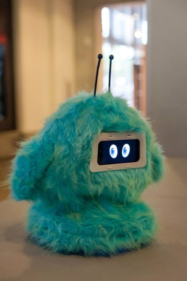 34230613-EDEB-40D2-885E-EB0AA1EC7741 Romibo is a small, teal/blue and fuzzy robot with a screen for eyes and 2 black antennas. Building Robots.