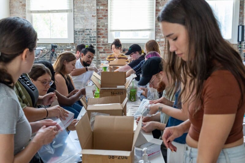 The Online Optimism team works to pack harm reduction kits at our annual retreat