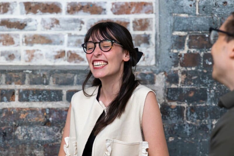 Jordan laughs while talking to Flynn in the office