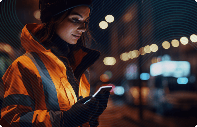 Young woman looking at her phone on city street