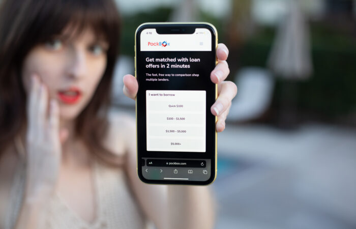 Pockbox instant loans Woman holding a phone that displays PockBox instant loan choices